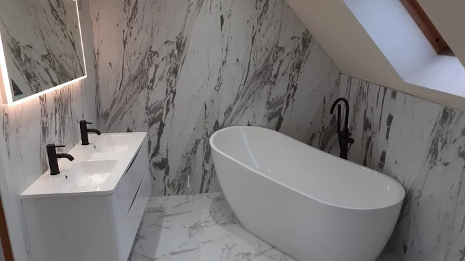 Modern bathroom with freestanding bath, walk-in shower and brushed brass taps fitted by SES Renovations