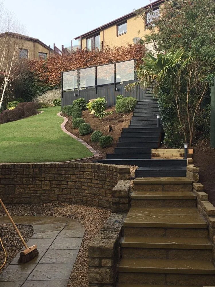 Beautifully landscaped Scottish garden with paving, lawn and timber fencing